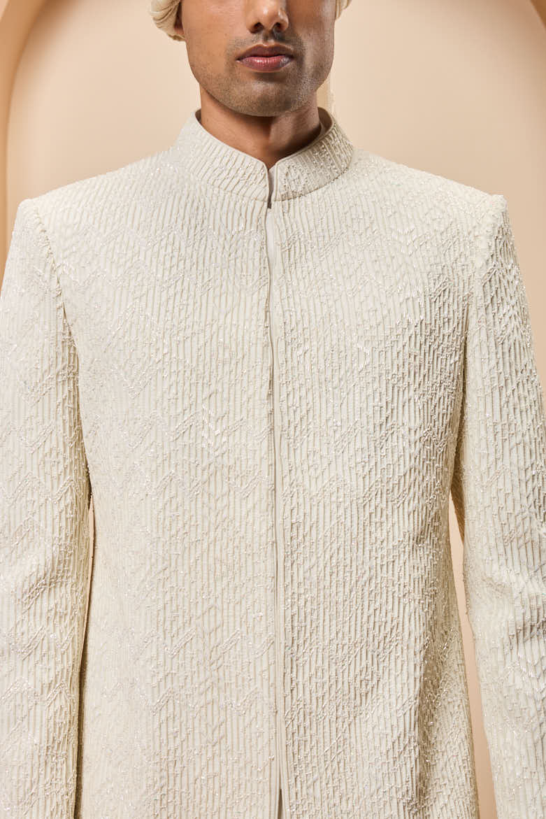 Ivory sherwani detailing with pearl,cutdana and pintex work
