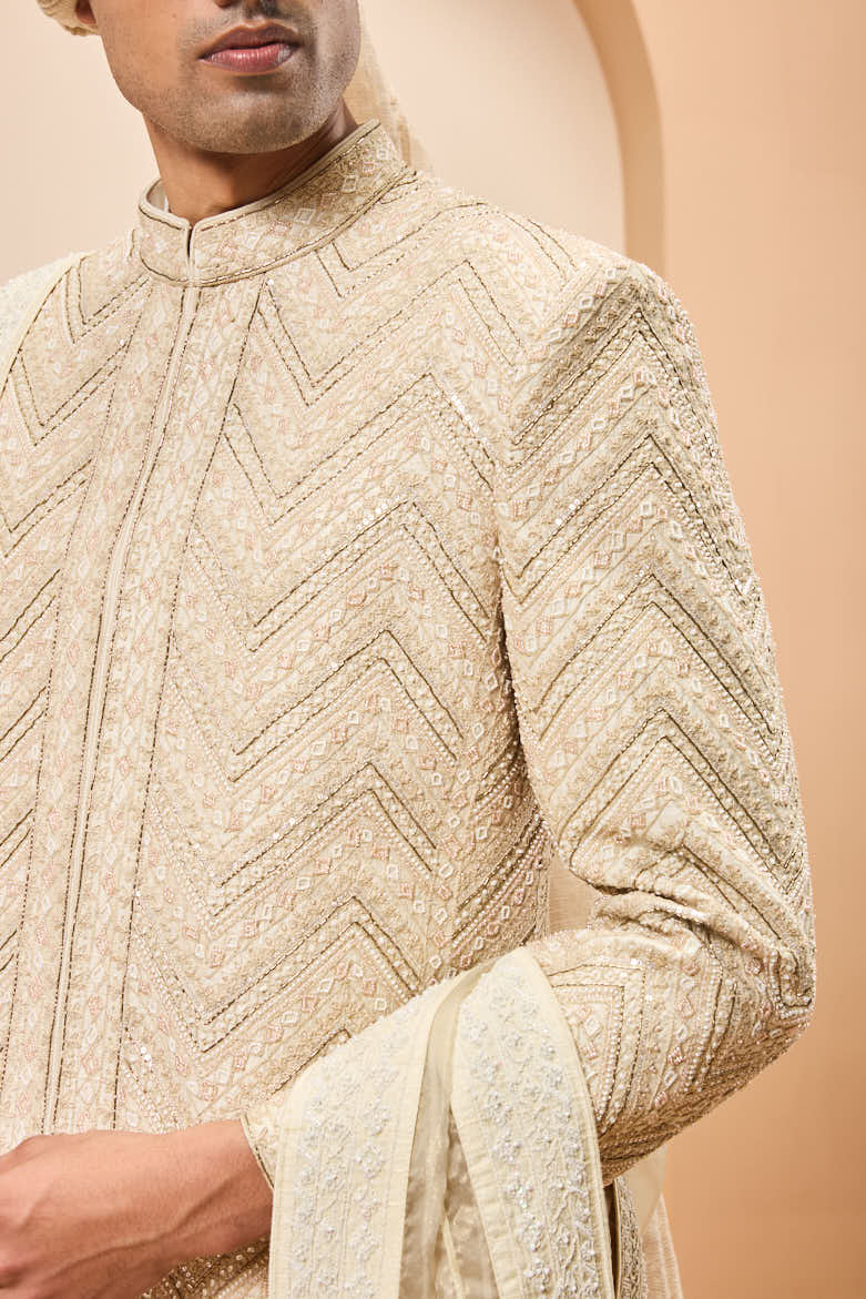 Ivory sherwani detailing with gold zari ,pearl,sequins and spring work