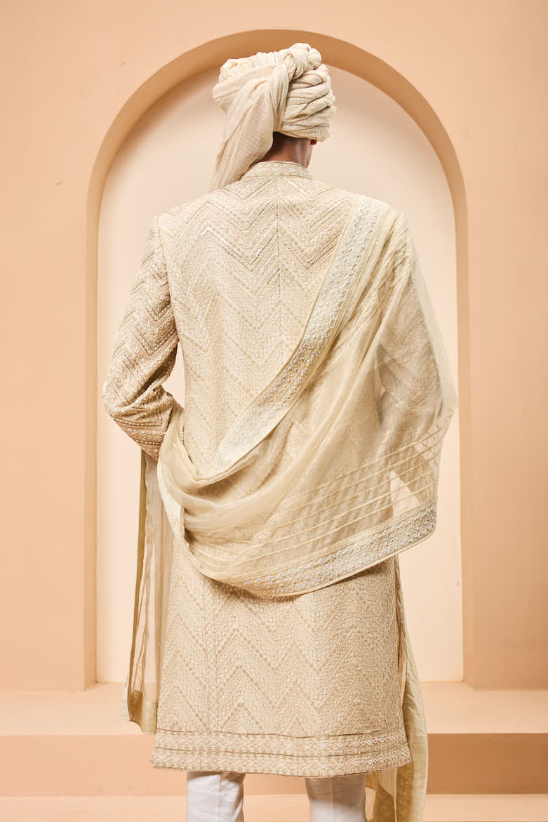 Ivory sherwani detailing with gold zari ,pearl,sequins and spring work