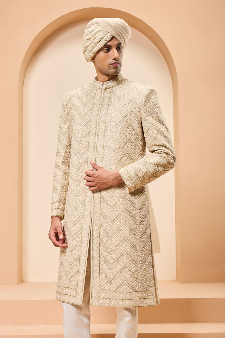Ivory sherwani detailing with gold zari ,pearl,sequins and spring work