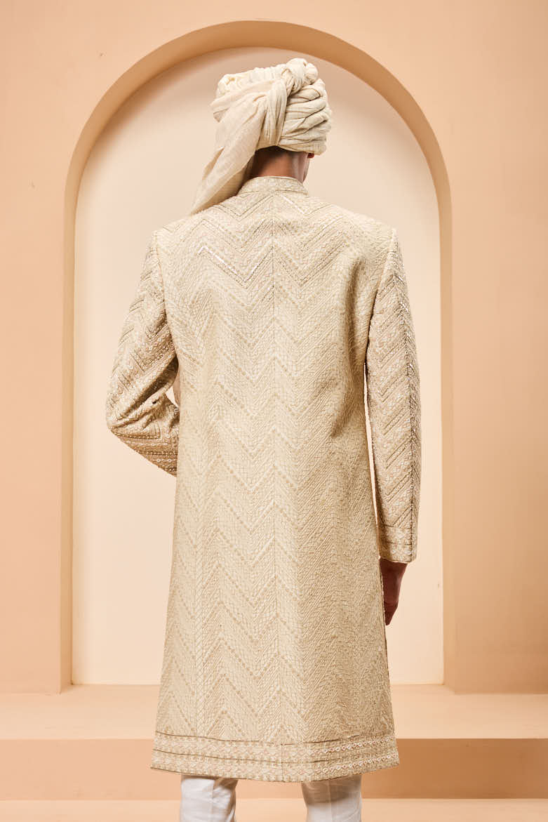 Ivory sherwani detailing with gold zari ,pearl,sequins and spring work