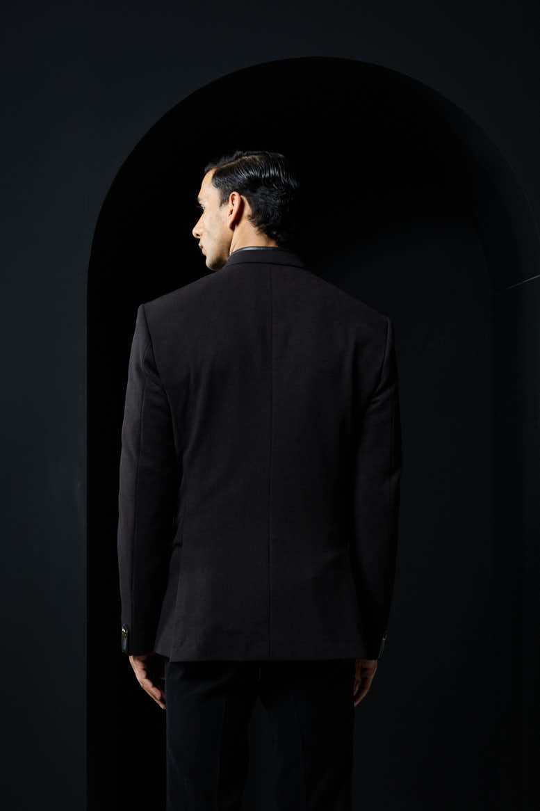 Black bandhgala with slant cut detailing with golden button and with satin taping
