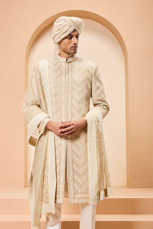 Ivory sherwani detailing with gold zari ,pearl,sequins and spring work