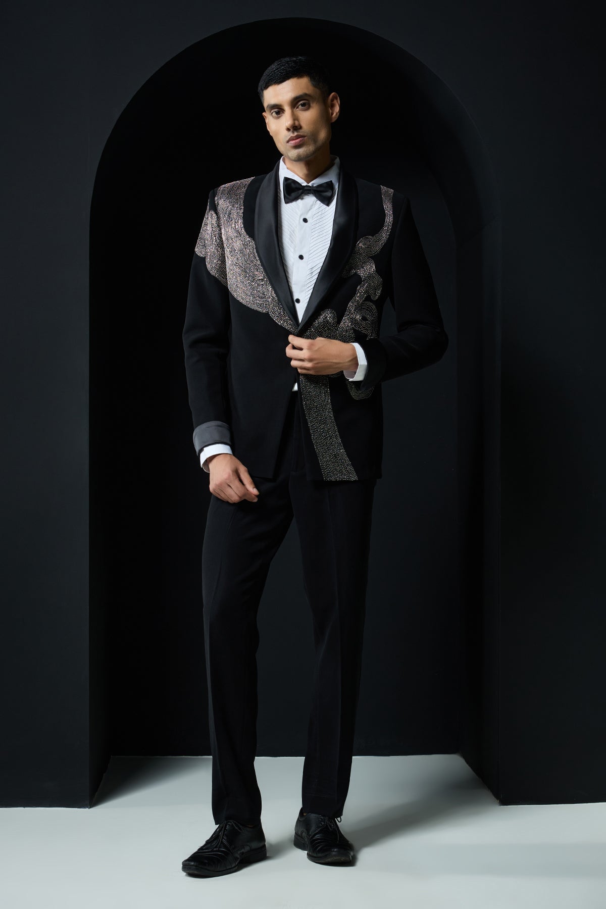Black tuxedo highlighted with silver zari , cutdana and peals