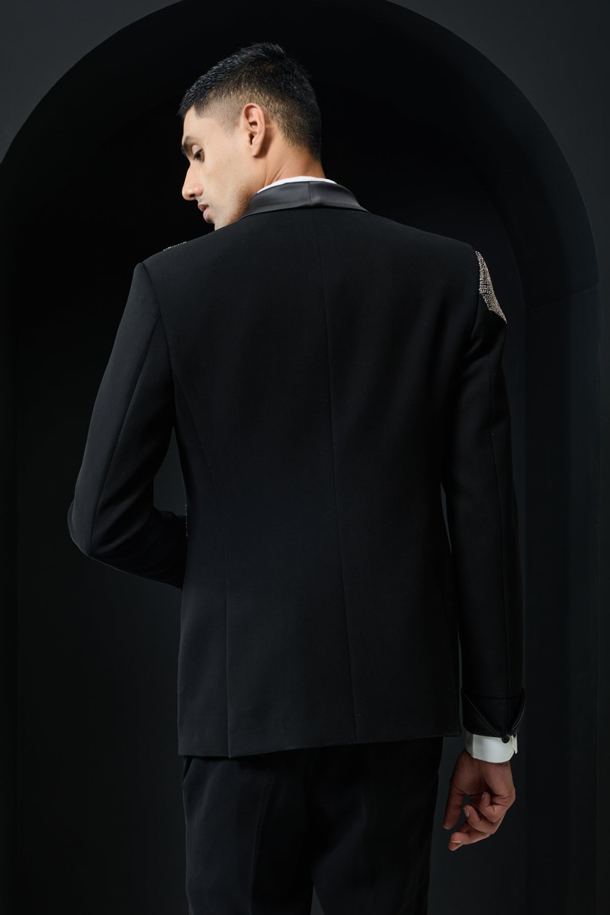 Black tuxedo highlighted with silver zari , cutdana and peals
