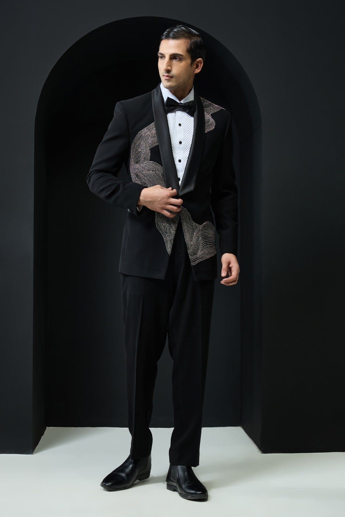 Black tuxedo highlighted with silver zari , cutdana and peals