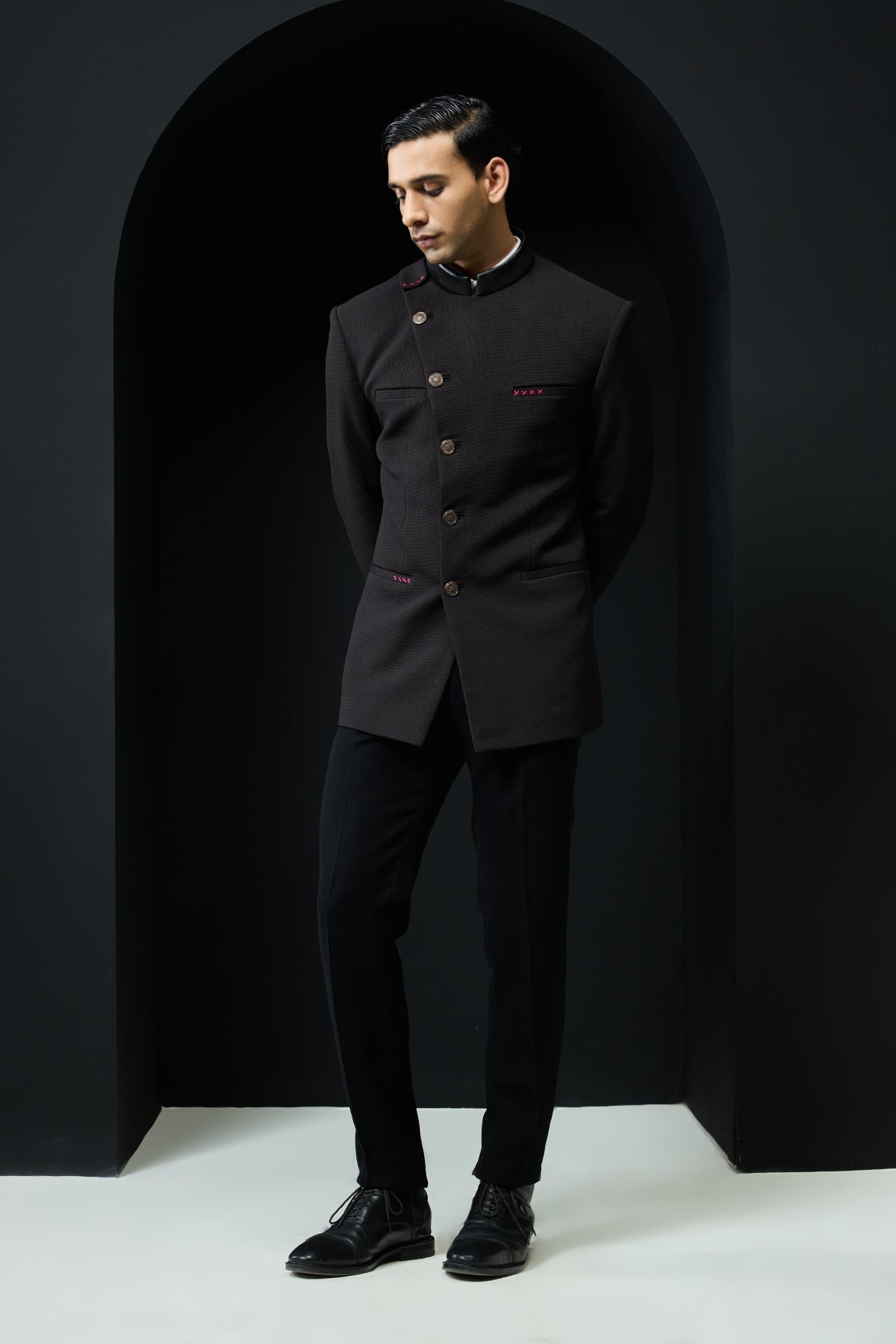 Black bandhgala with slant cut detailing with golden button and with satin taping