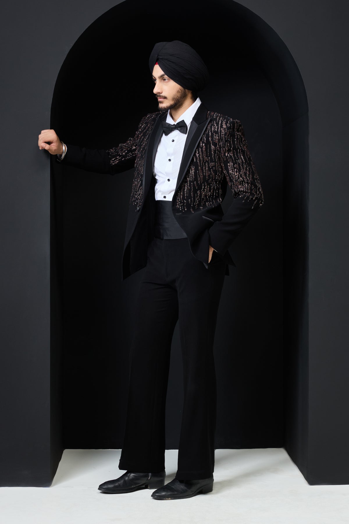 Black tuxedo highlighted with pearls, sequins and thread work
